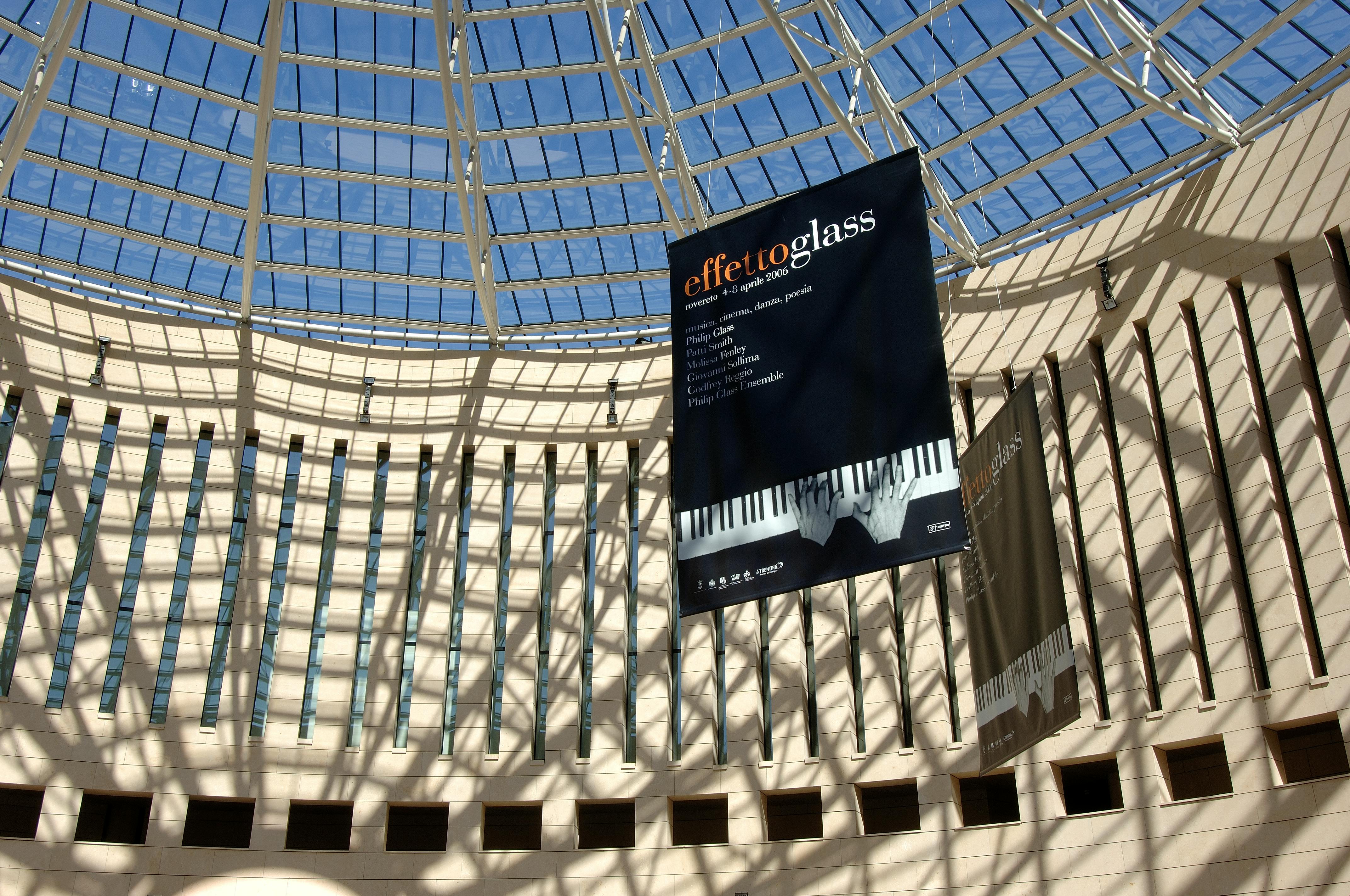 Exterior of the Mart museum with the poster of the Futuro Presente festival - Effetto Glass