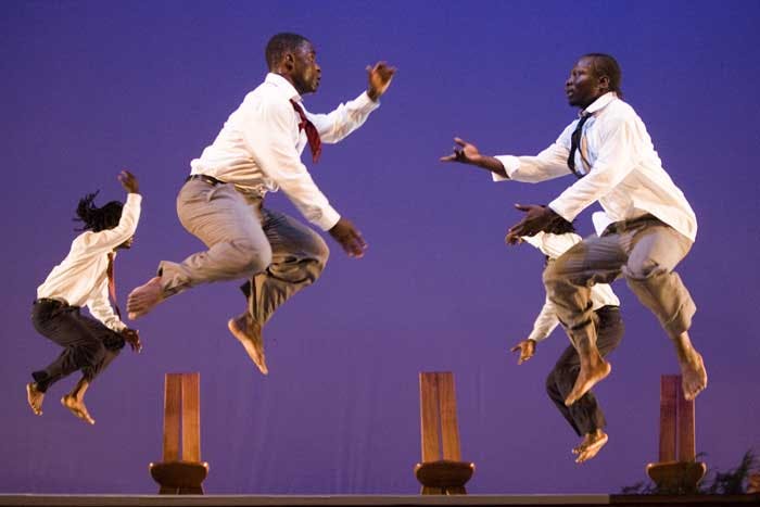 Four artists jumping with a blue background