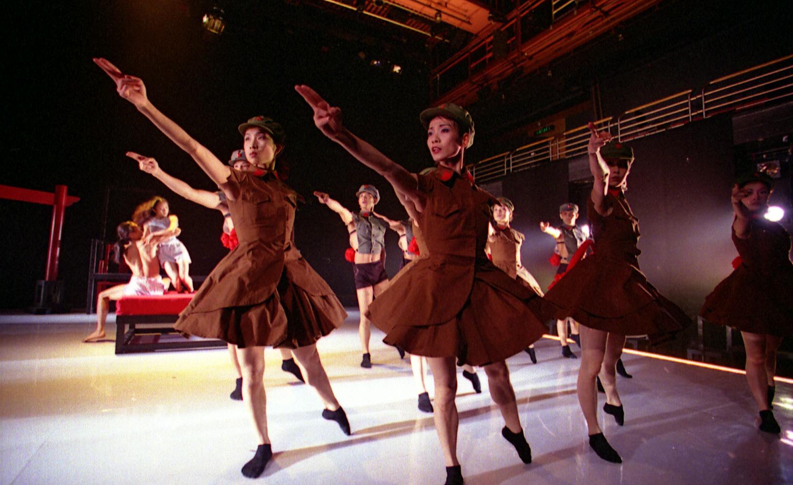 un gruppo di ballerine vestite da soldati che indicano davanti a loro