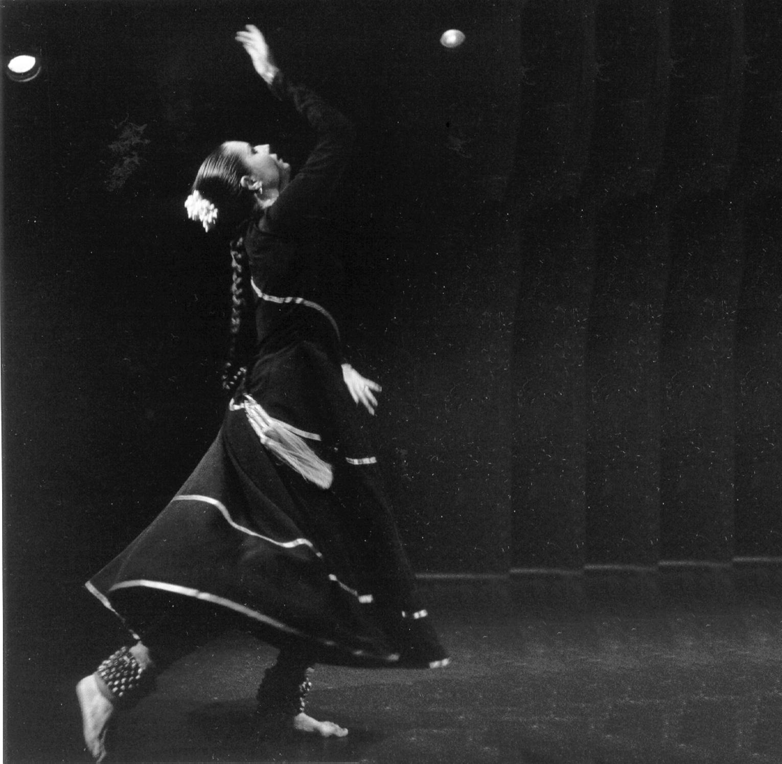 A dancer in traditional Indian attire performing.