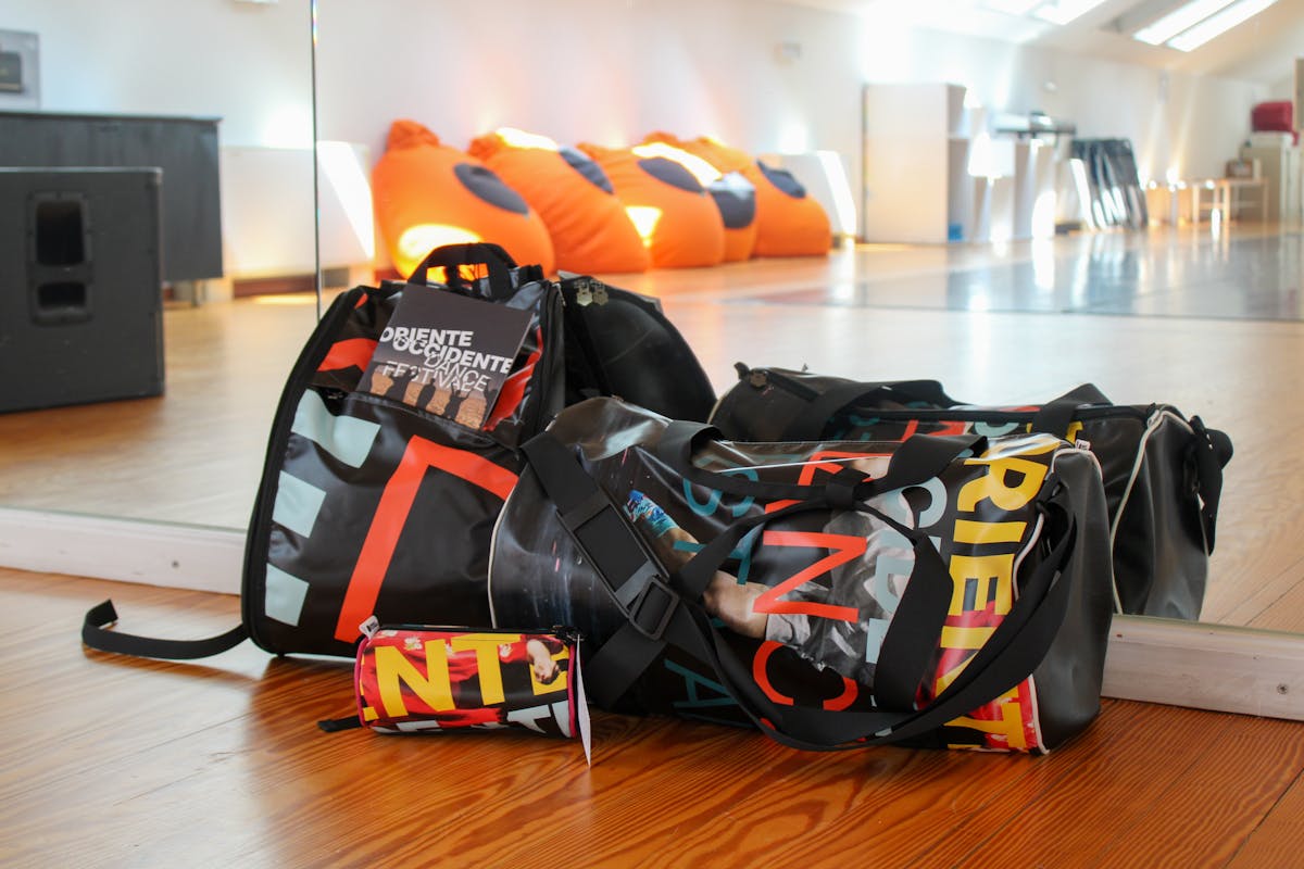 Photo of a bag, a backpack and a pencil case made of communication materials from the last edition of the Festival