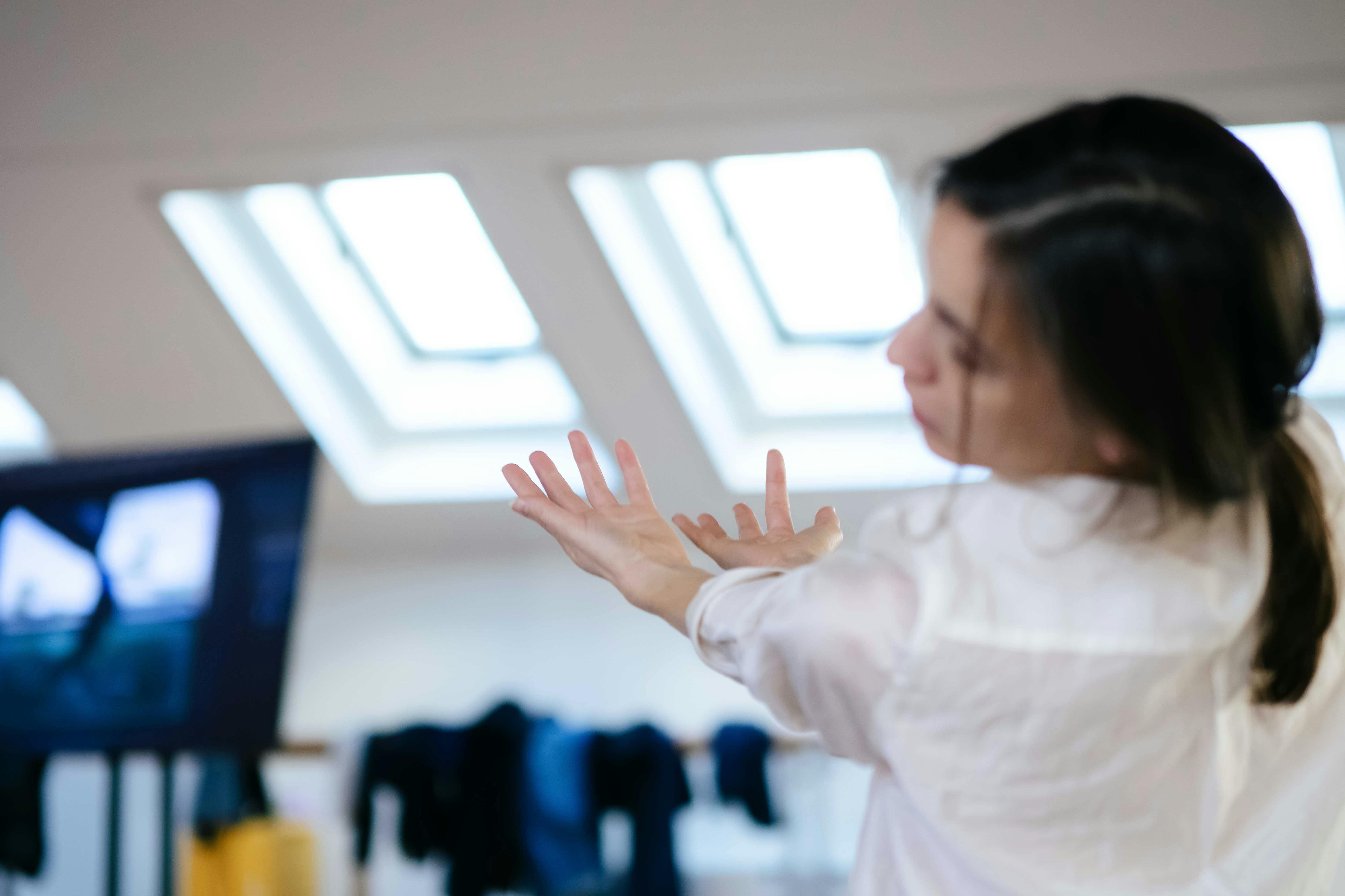 In the centre of the photograph Stefania Tansini's hands, in the foreground on the right side the back of her head is out of focus