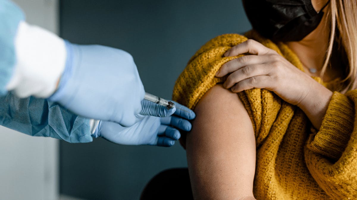 an image of a patient getting a shot by a doctor