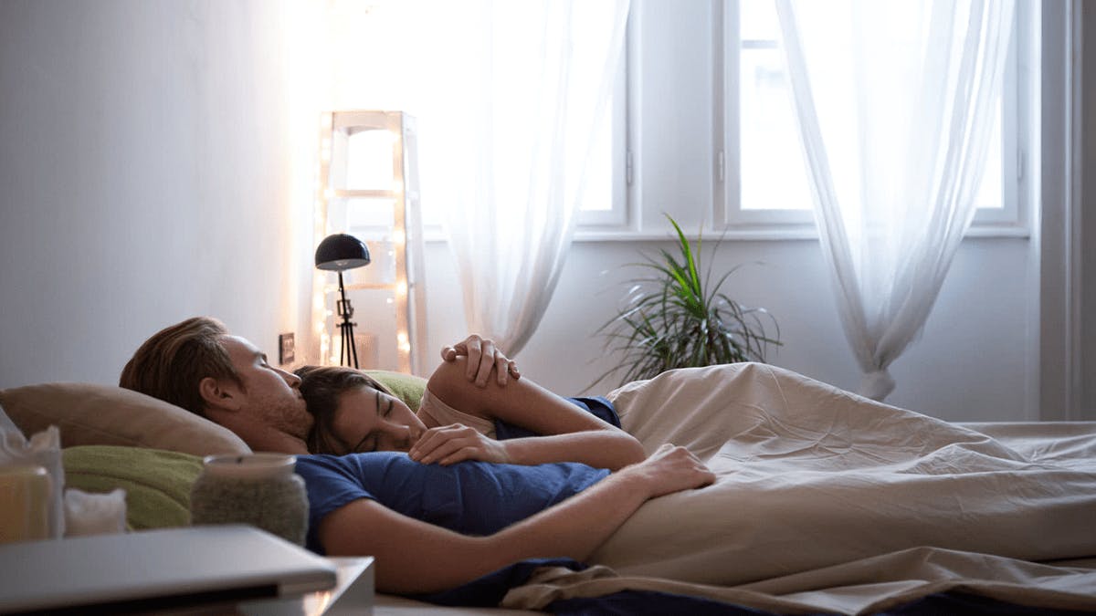 Woman and man resting in bed.