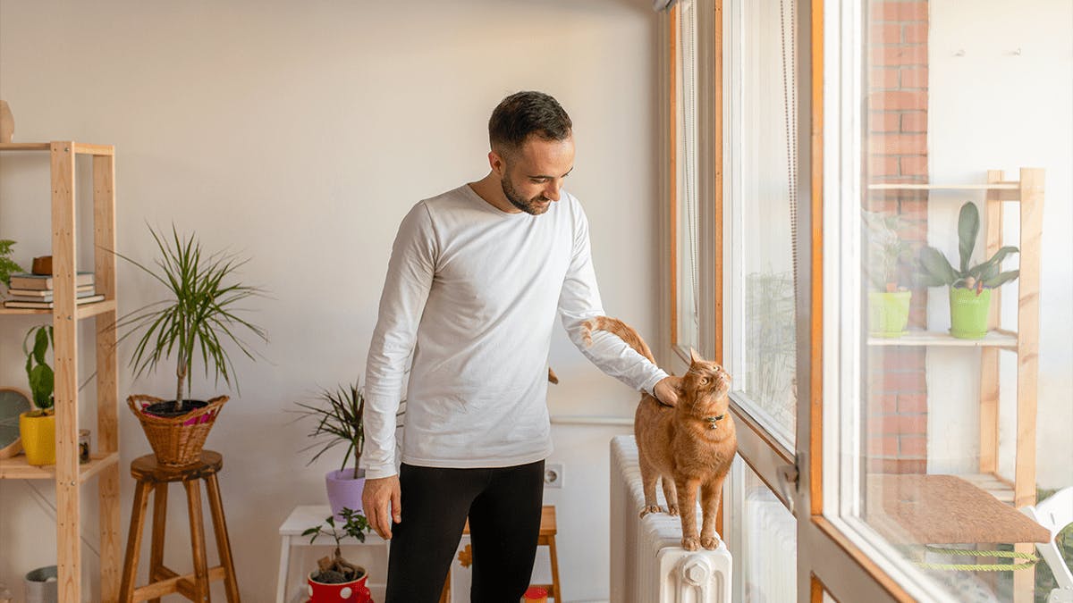 Man petting a cat.