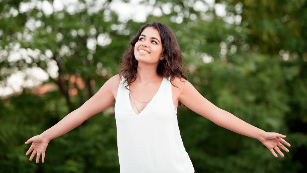 an image of a woman with a white dress with her hands spread out