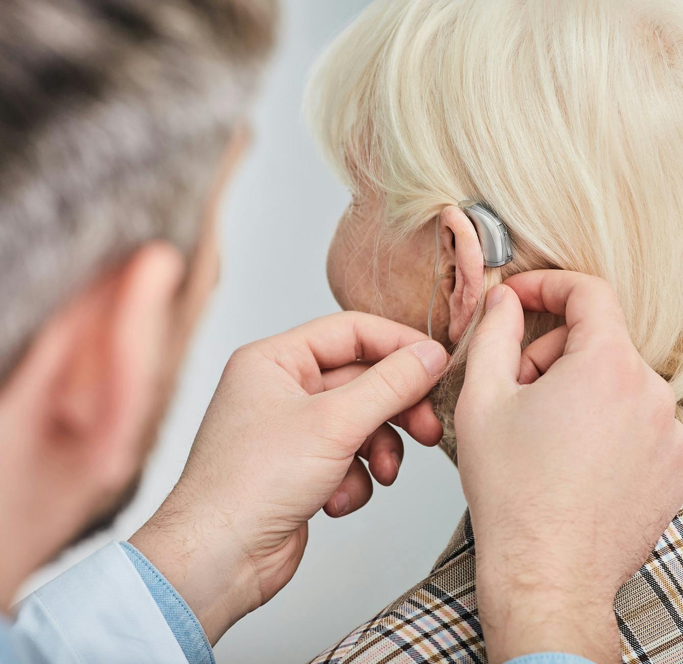 Physician fitting patient with hearing aid