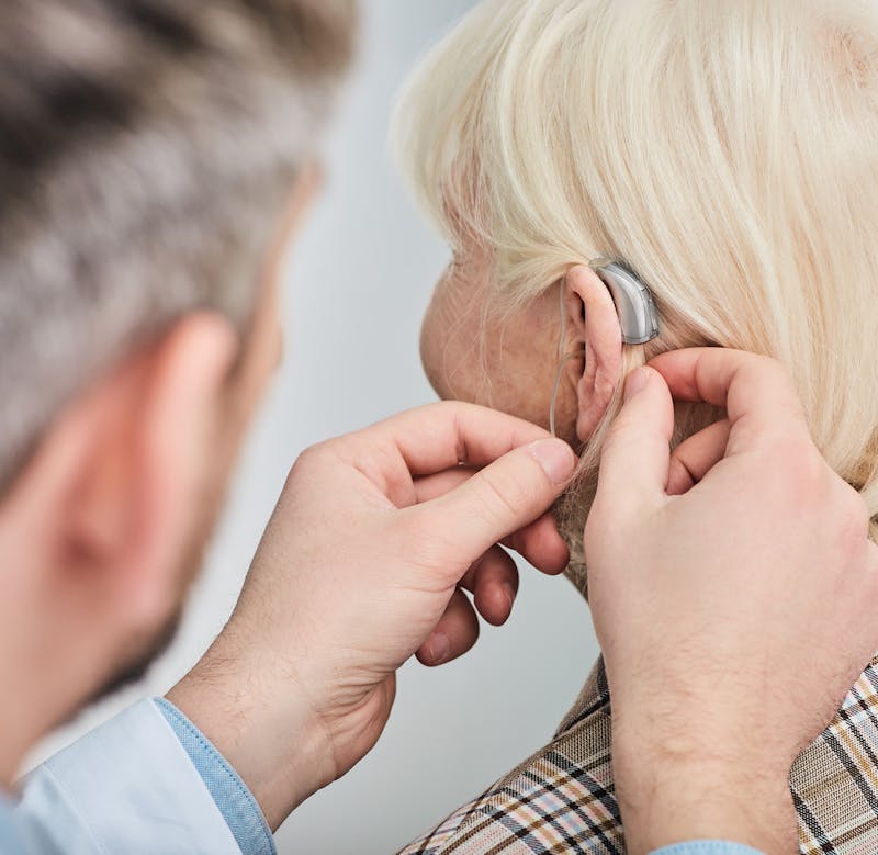 Physician fitting patient with hearing aid