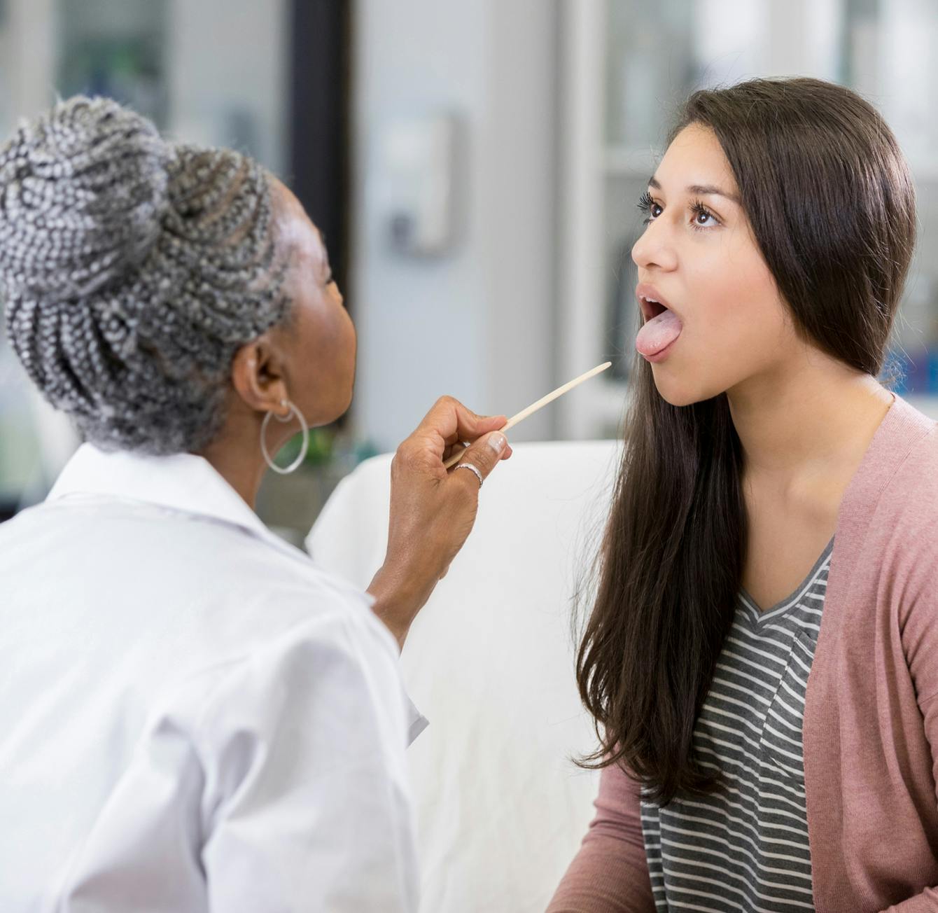 doctor checking patient's throat