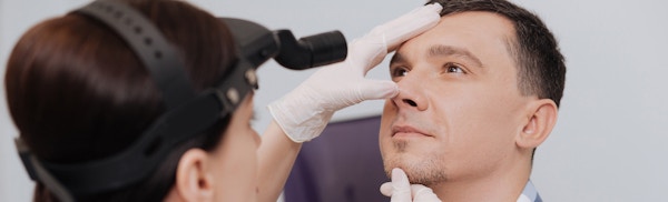 Doctor looking at a patient's nose
