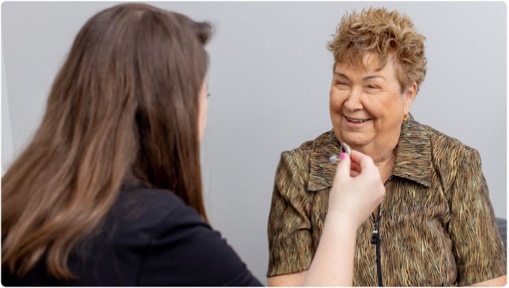 ENT (Otolaryngologist) showing a hearing aid to a patient