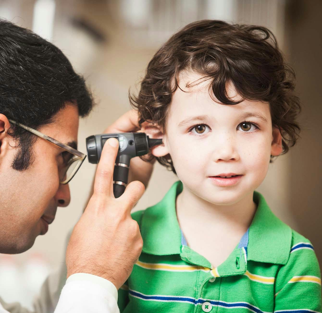 young boy getting an ear exam
