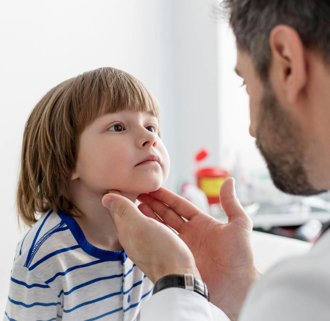 doctor checking a child's tonsil area