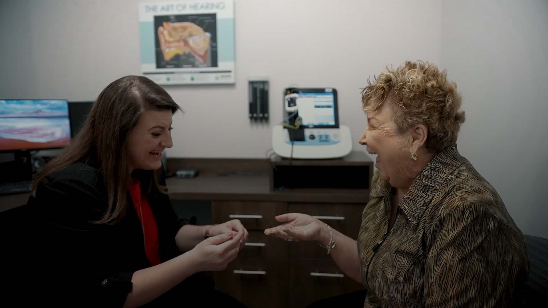 an image of a doctor giving a patient of hearing aid