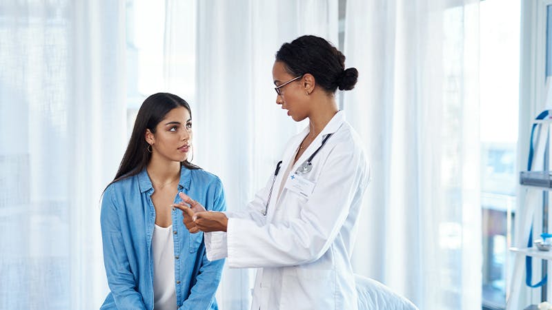 Female physician with female patient