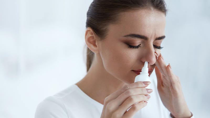 Woman trying to address a stuffy nose