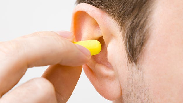 a close up of a male place in an ear plug