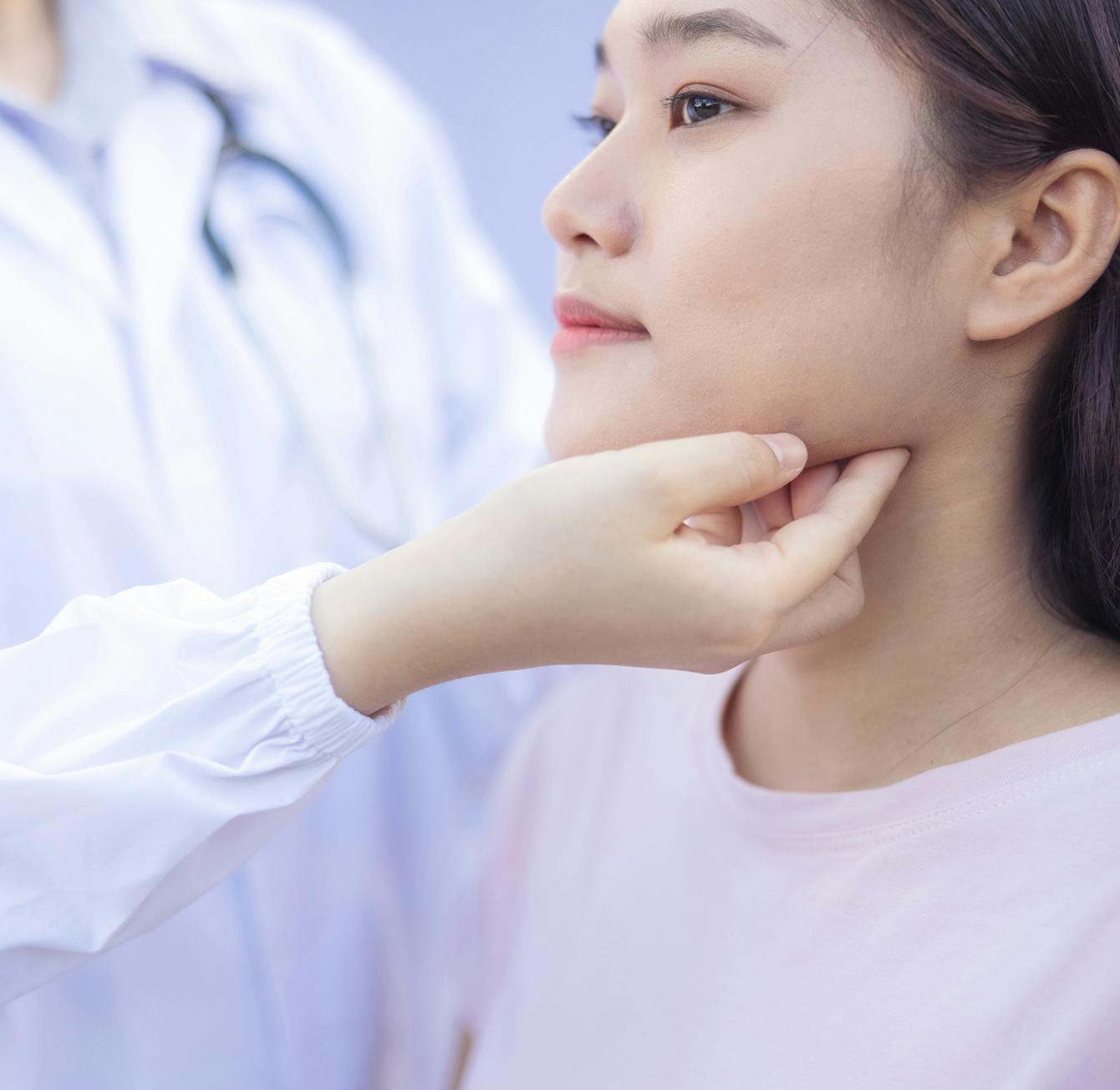 doctor inspecting patient throat