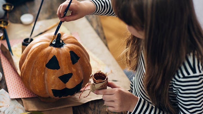 Girl Painting a Pumpkin