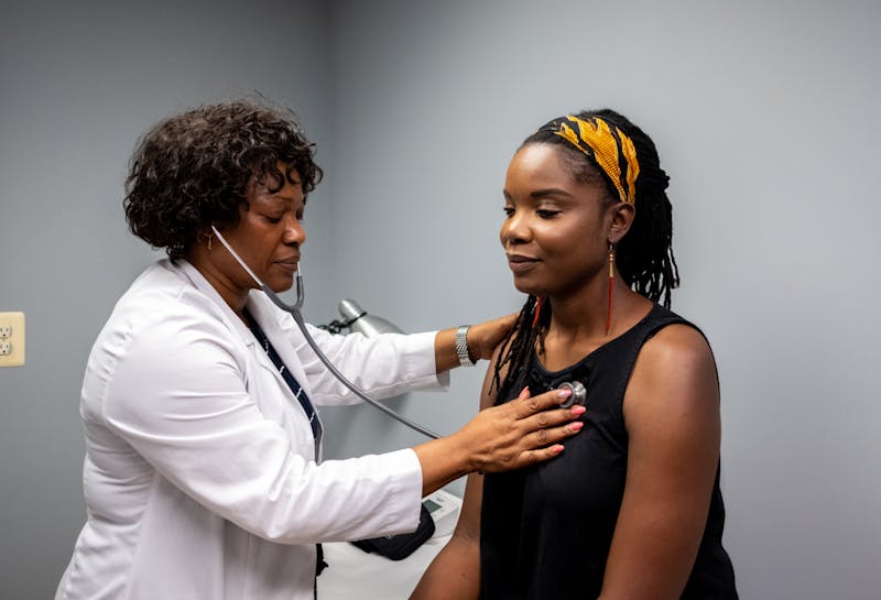 a doctor checking a patients heartbeat