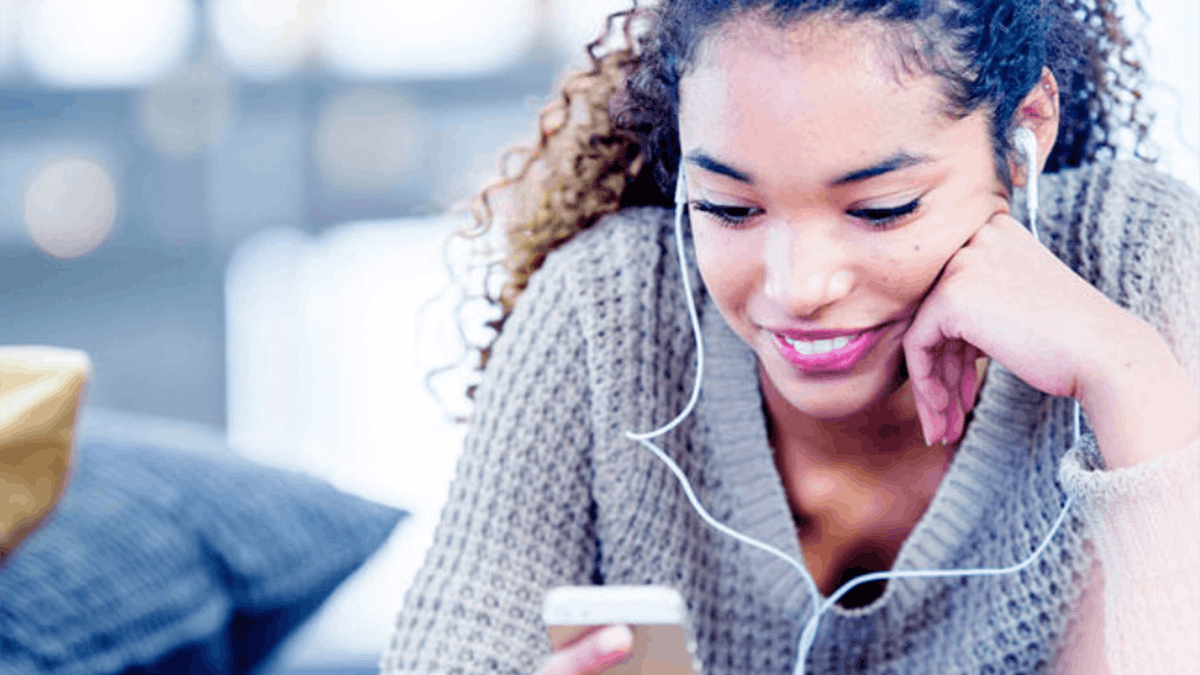 an image of a woman listening to something through headphones