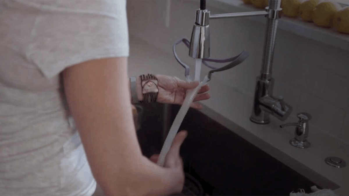 an image of a woman washing her sleep apnea tube