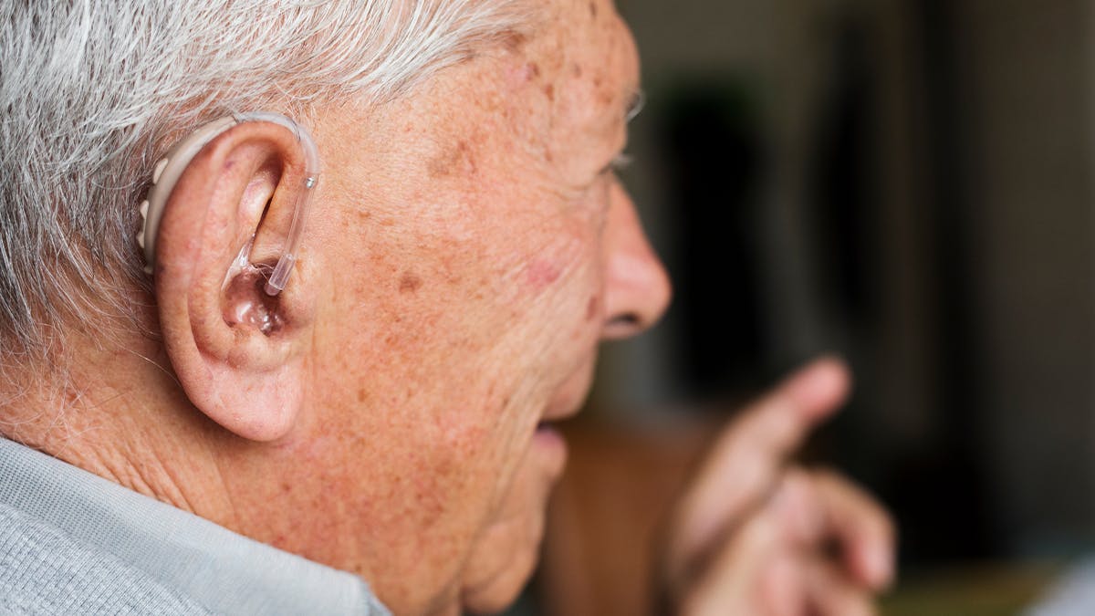 an image of an older man with a hearing aid