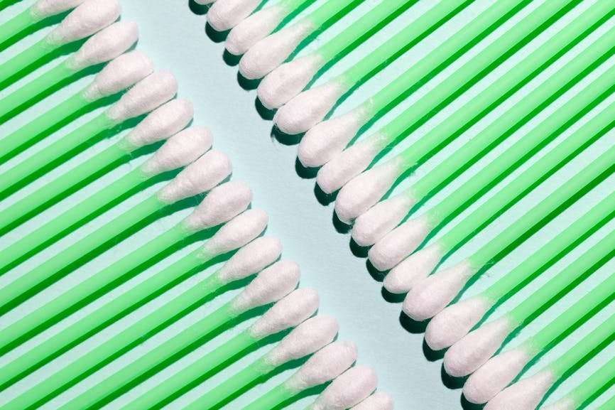 Green q-tips lined up