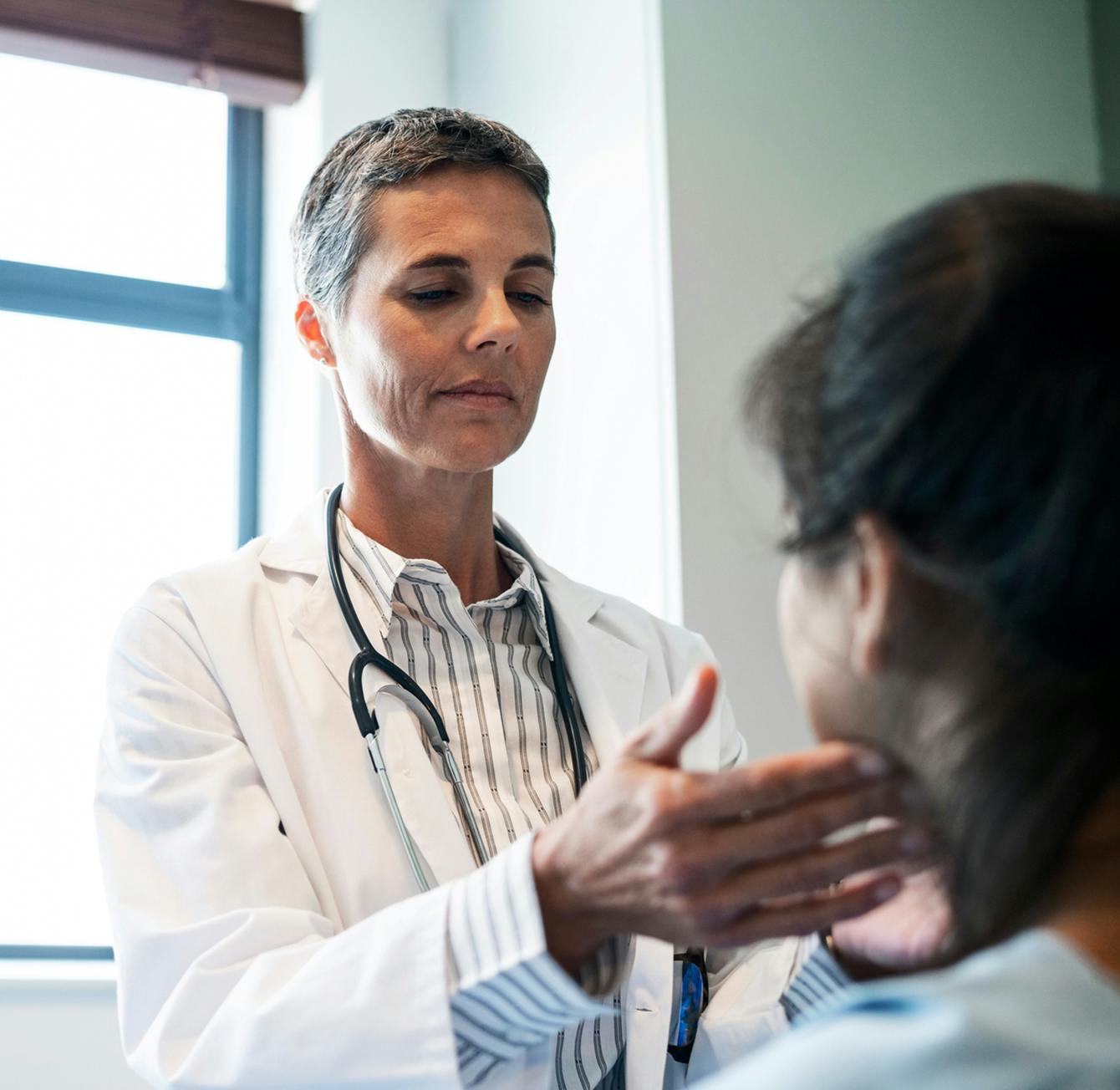 doctor inspecting patient throat