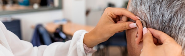 man getting a hearing aid put on
