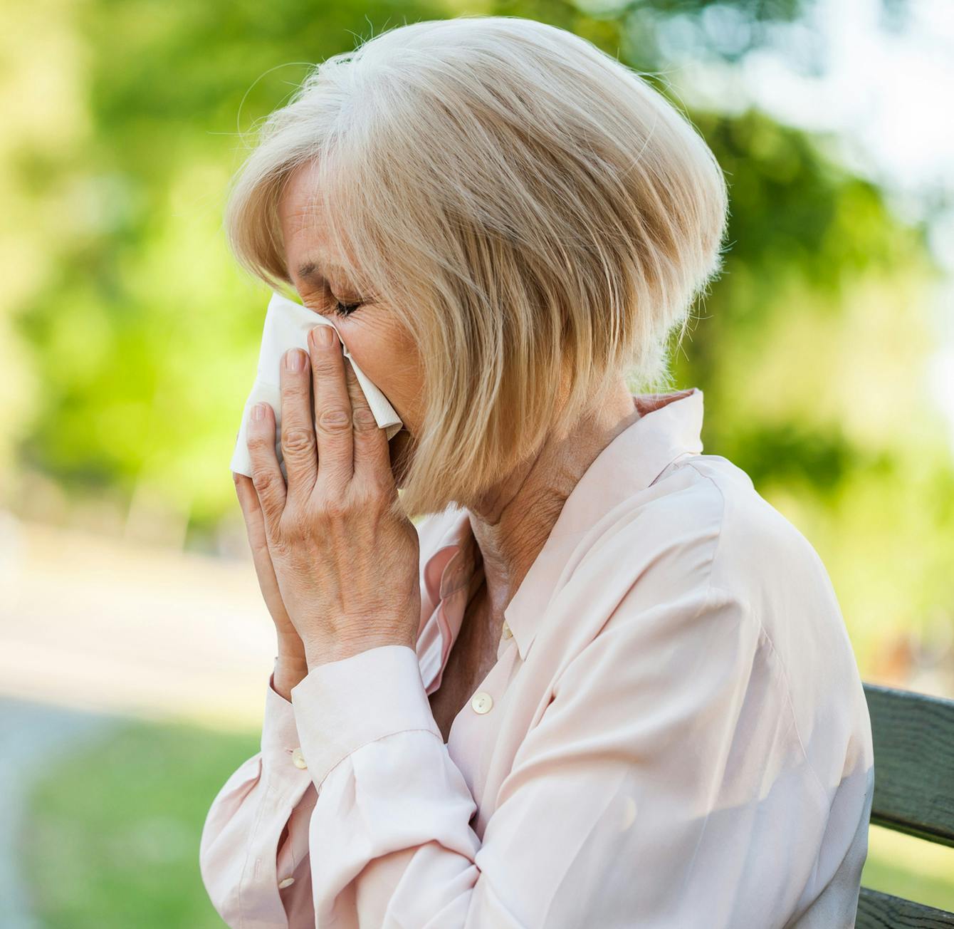 woman blowing her nose