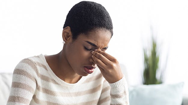 an image of a woman showing that she has sinus pressure