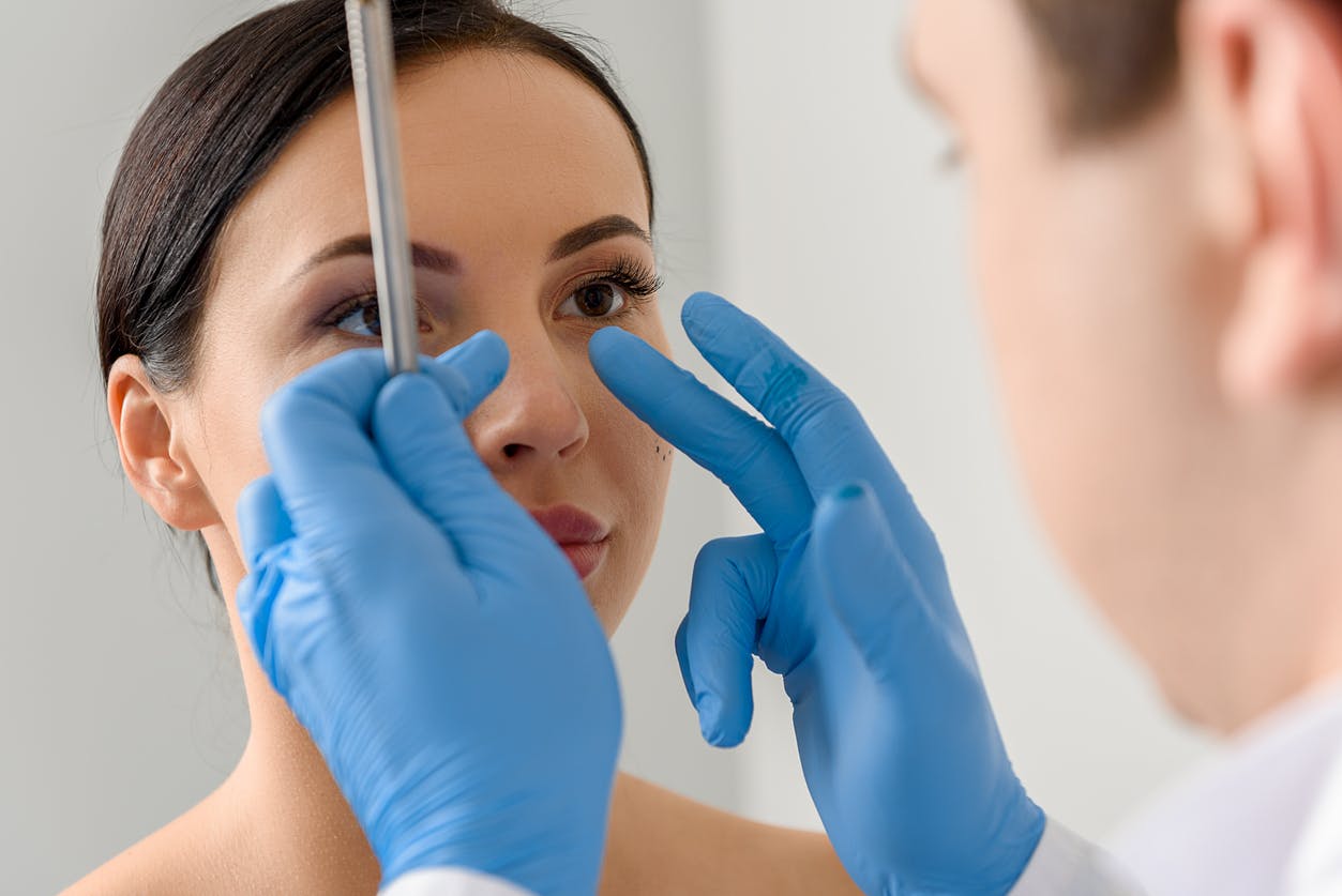 Doctor examining a patient's nose