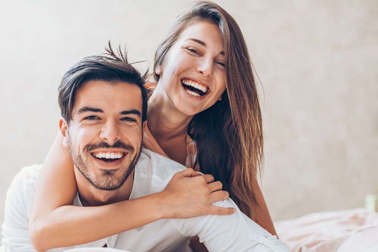 Woman with her arm around a man's neck