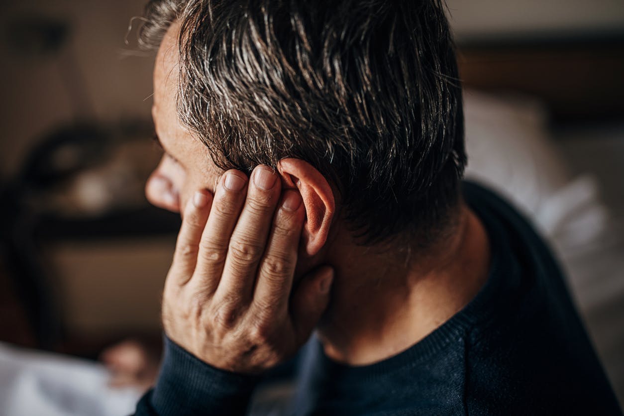 Man holding his ear in pain