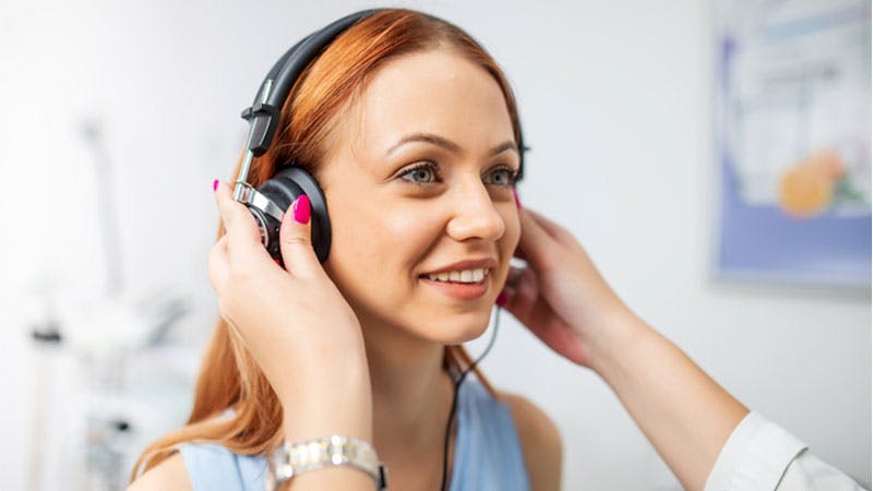 an image of a woman hearing headphones