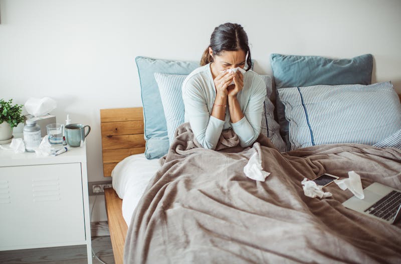 Woman sick with allergies in bed, not sleeping.