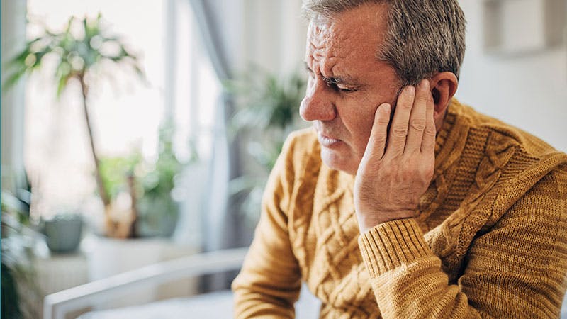 image of a older man having hearing issues