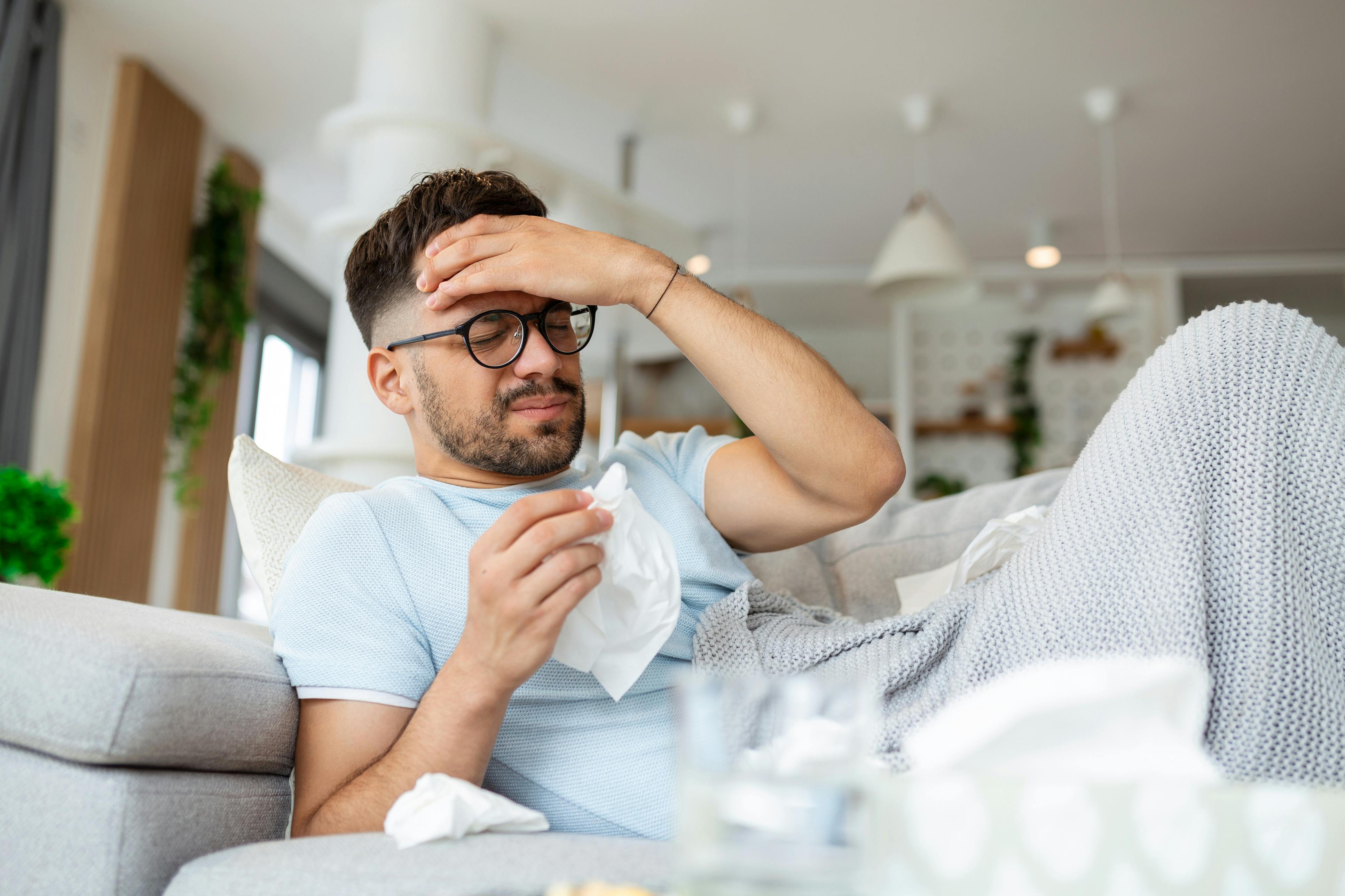 man laying on the couch sick