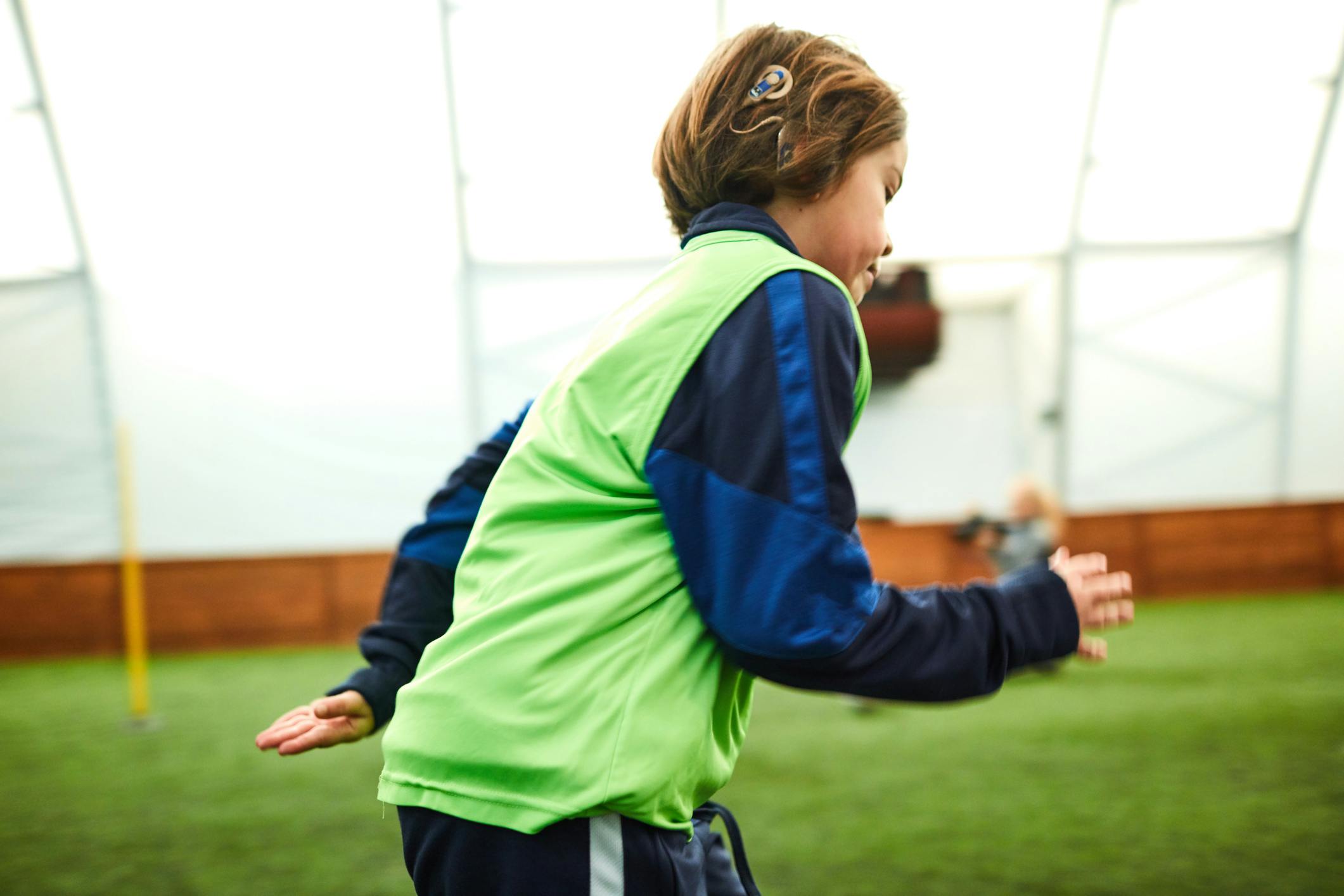 boy running and playing soccer