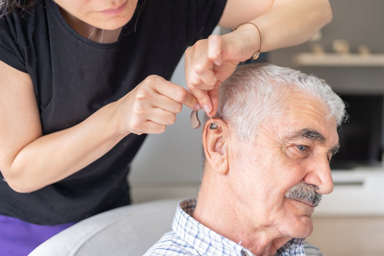 man getting fit for hearing aids