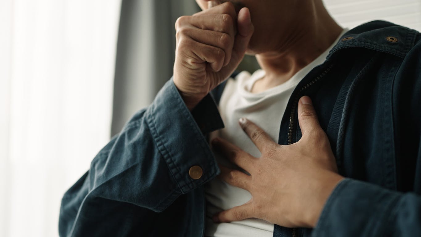 man coughing