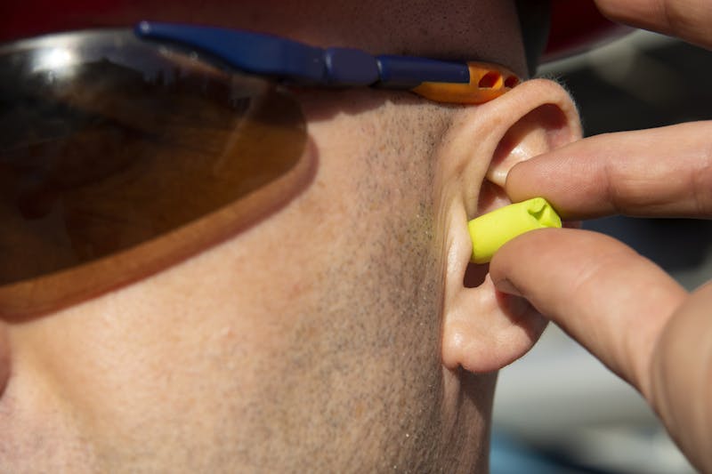 Person putting in ear plugs