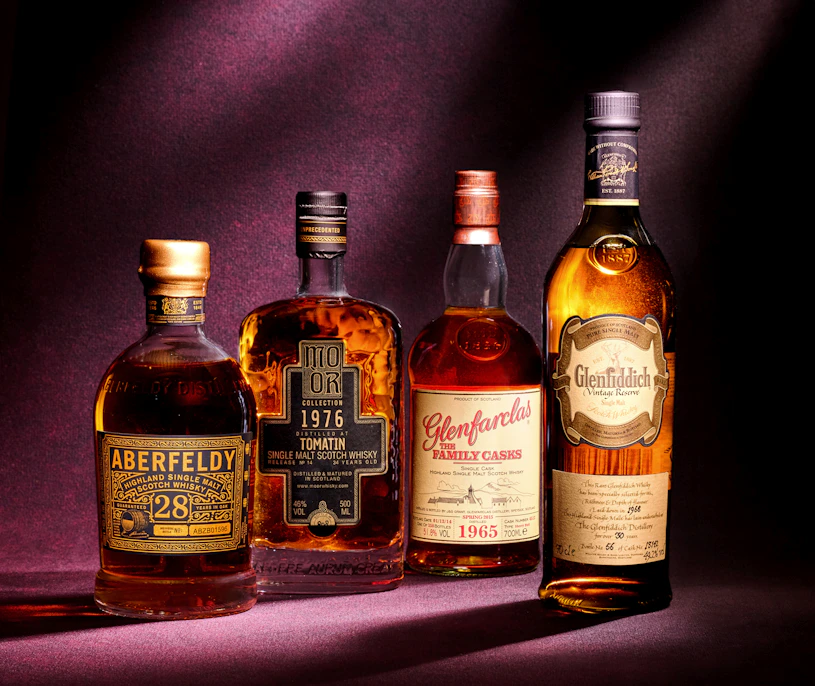 A premium group of investment-grade rare whiskies featuring iconic vintages. Shown are the Aberfeldy 28 Year Old, Tomatin 1976, Glenfarclas 1965, and Glenfiddich 1968, representing high-value assets in the whisky market