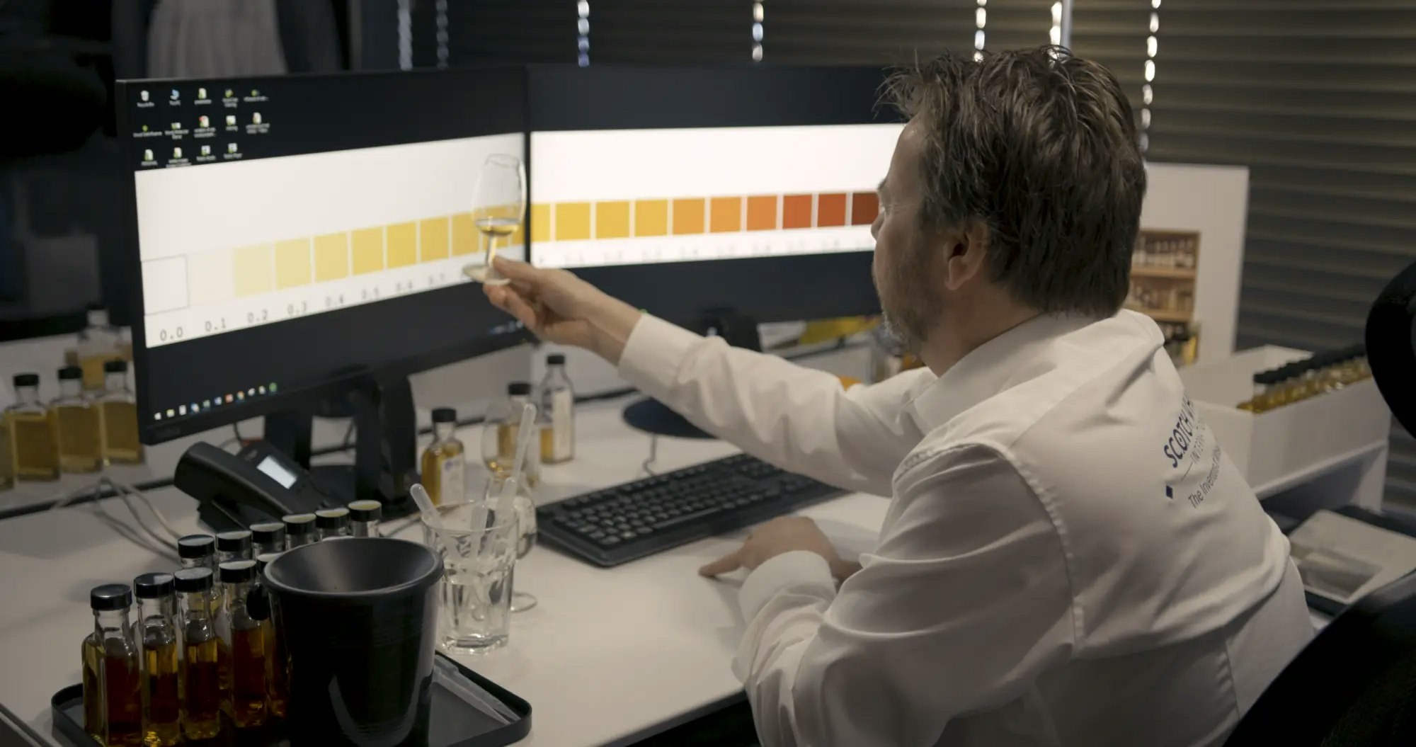 A whisky analyst assessing the colour of samples