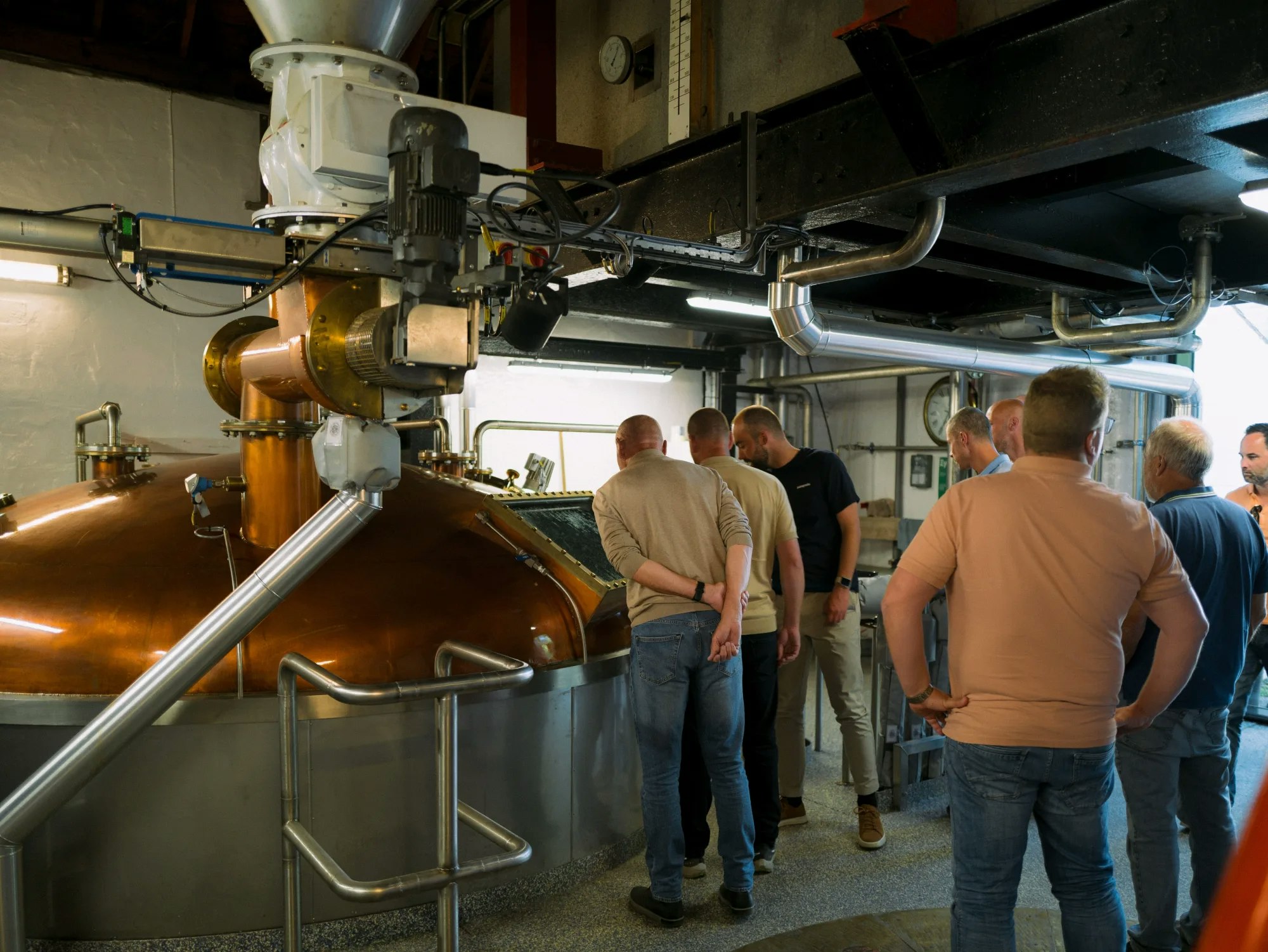 Visitors viewing the copper stills during a distillery visit