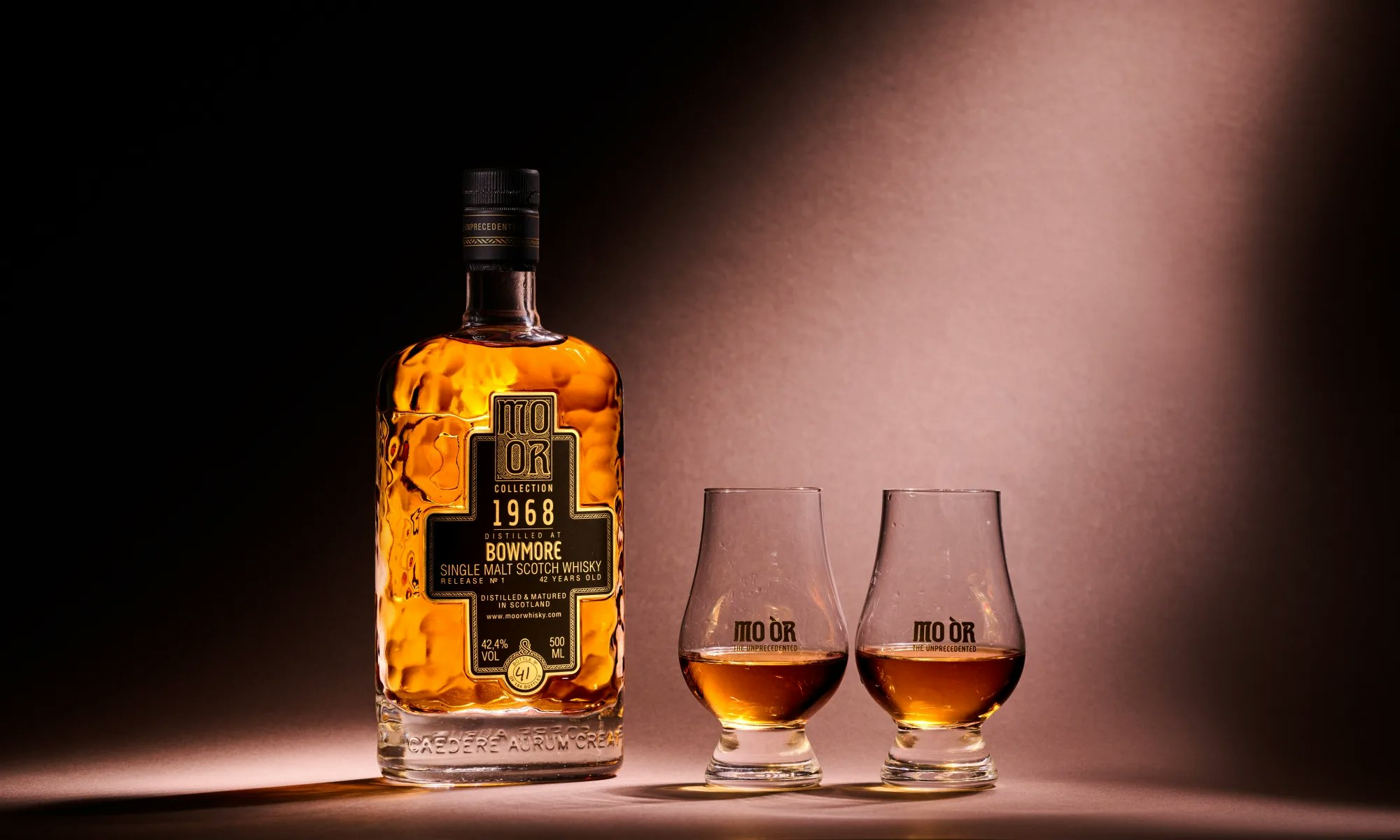 A bottle and two glasses of MO ÒR, the group's own brand