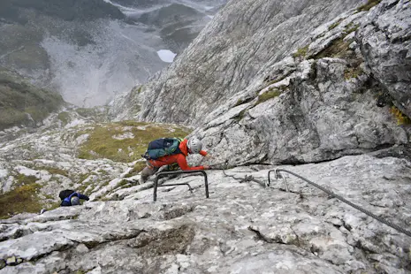 Climbing the Mangart via ferrata in the Julian Alps, Slovenian and Italian routes