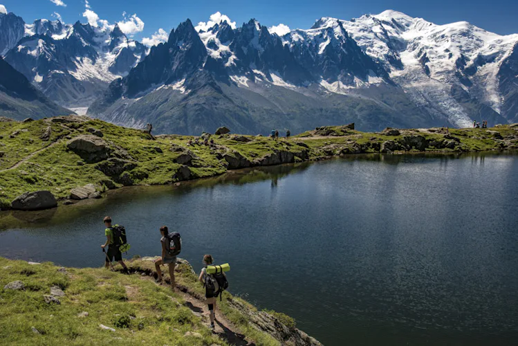 hikers by famous reflecting lake, aiguilles rouge