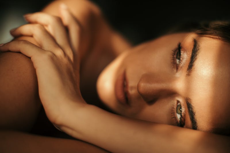Close up of woman looking away from camera while laying down